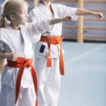 Young girls training karate moves
